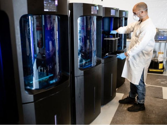 NXE 400 side by side with man pulling out Printed Part